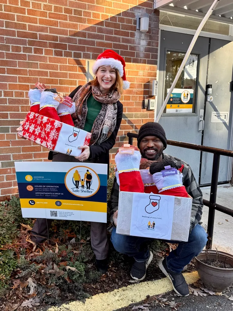 Two people with boxes of stockings at Counterflow’s Safe Shelter
